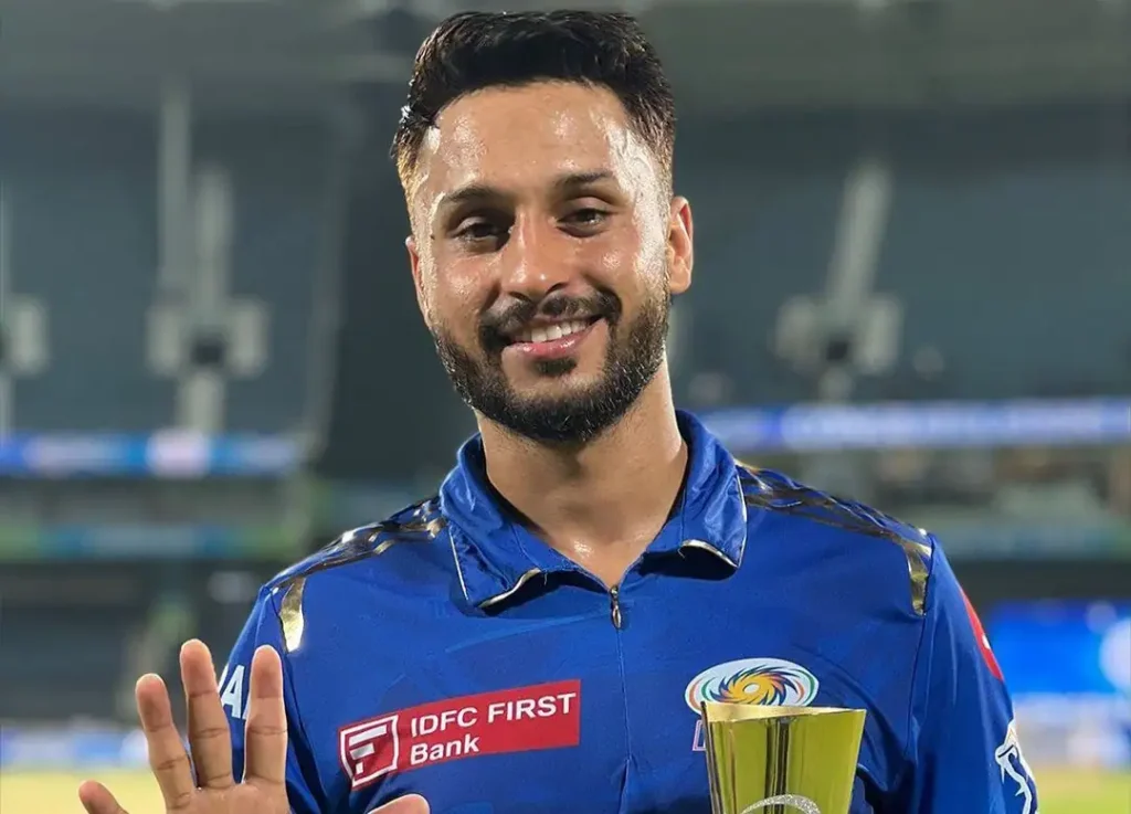 Aakash Madhwal posing in the front of camera with his man of the match award